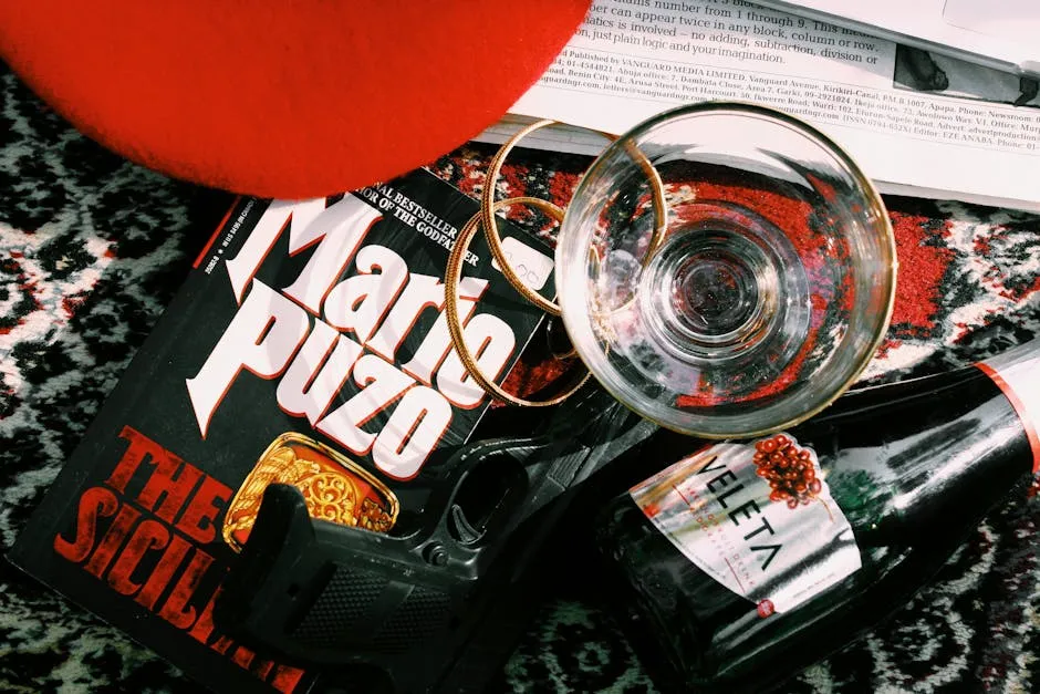 A Book, a Gun and a Bottle of Alcohol Lying on the Table